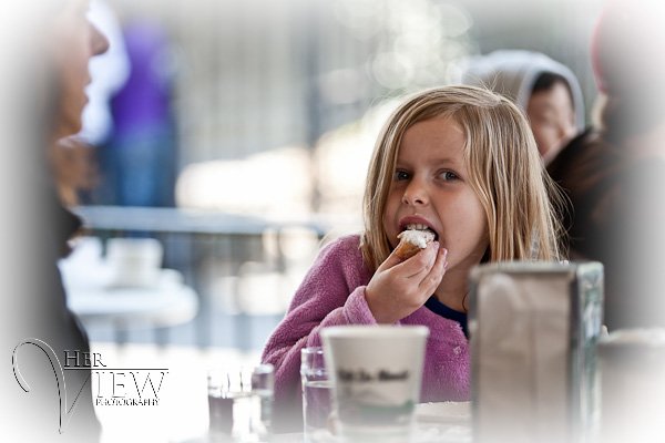 girl eating beignets